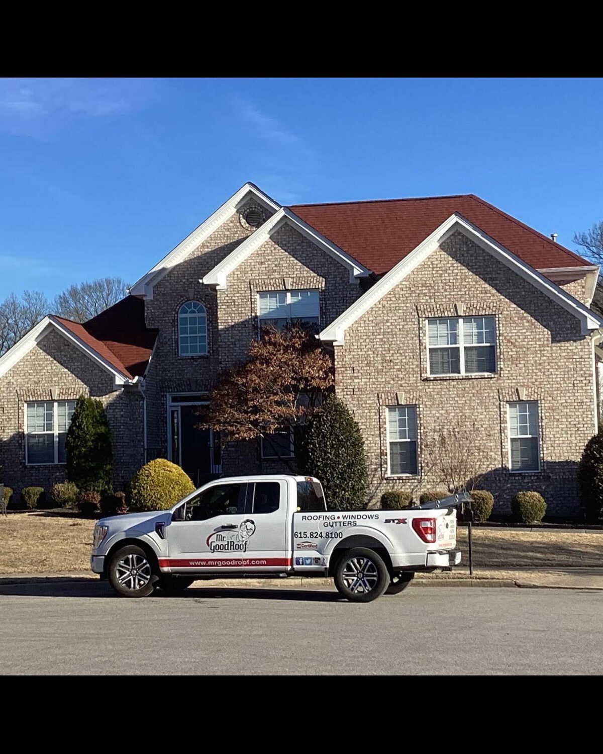 A white truck parked in front of a home