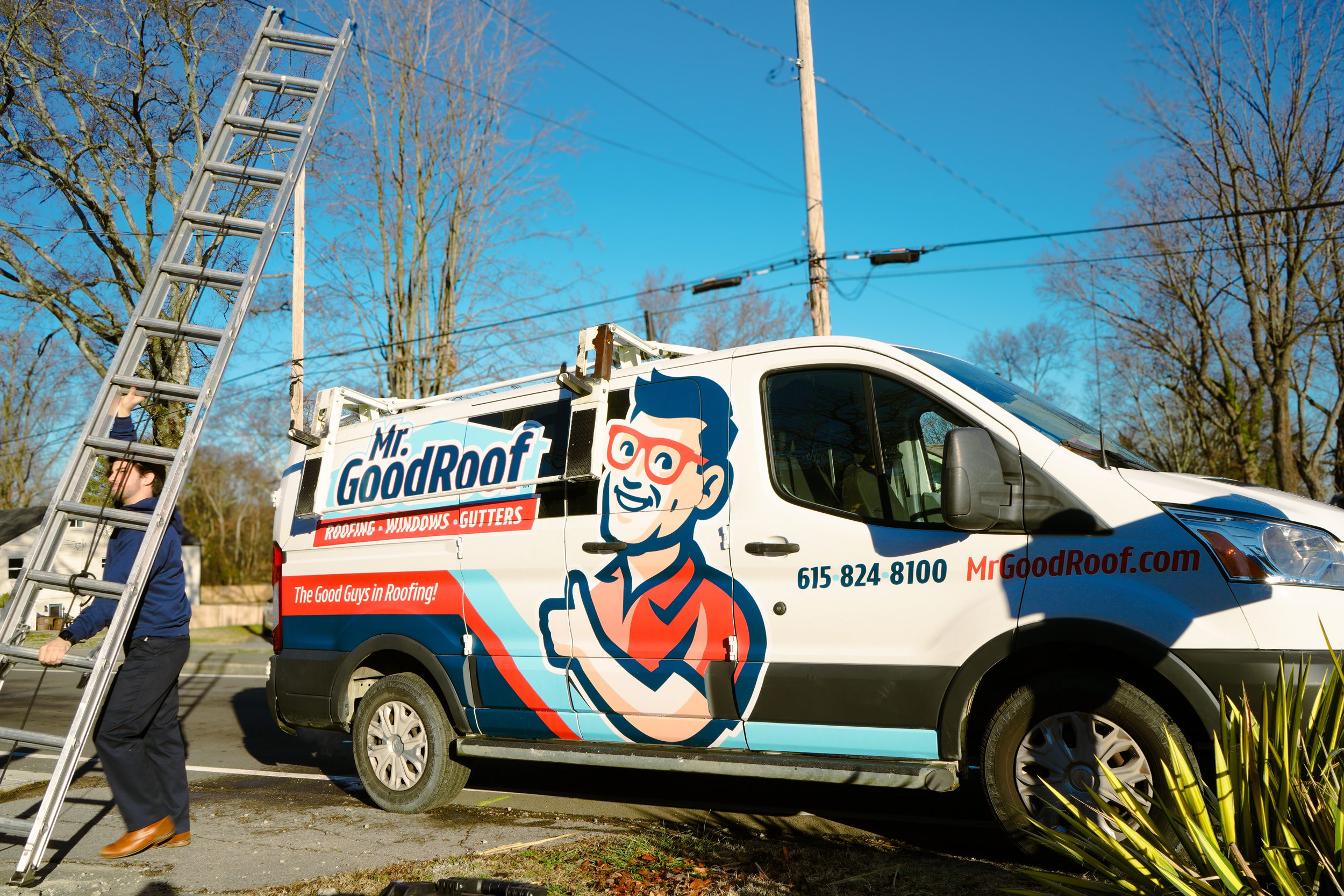 Two men in a white van going to fix gutters for mr goodroof