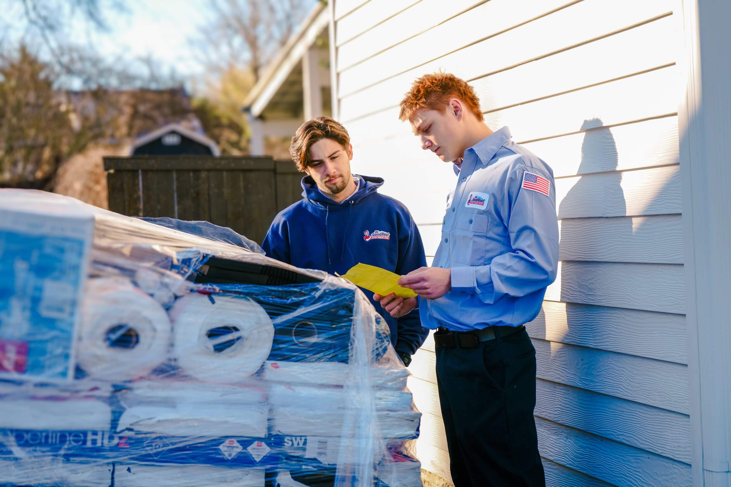 Two men looking at roofing equipment