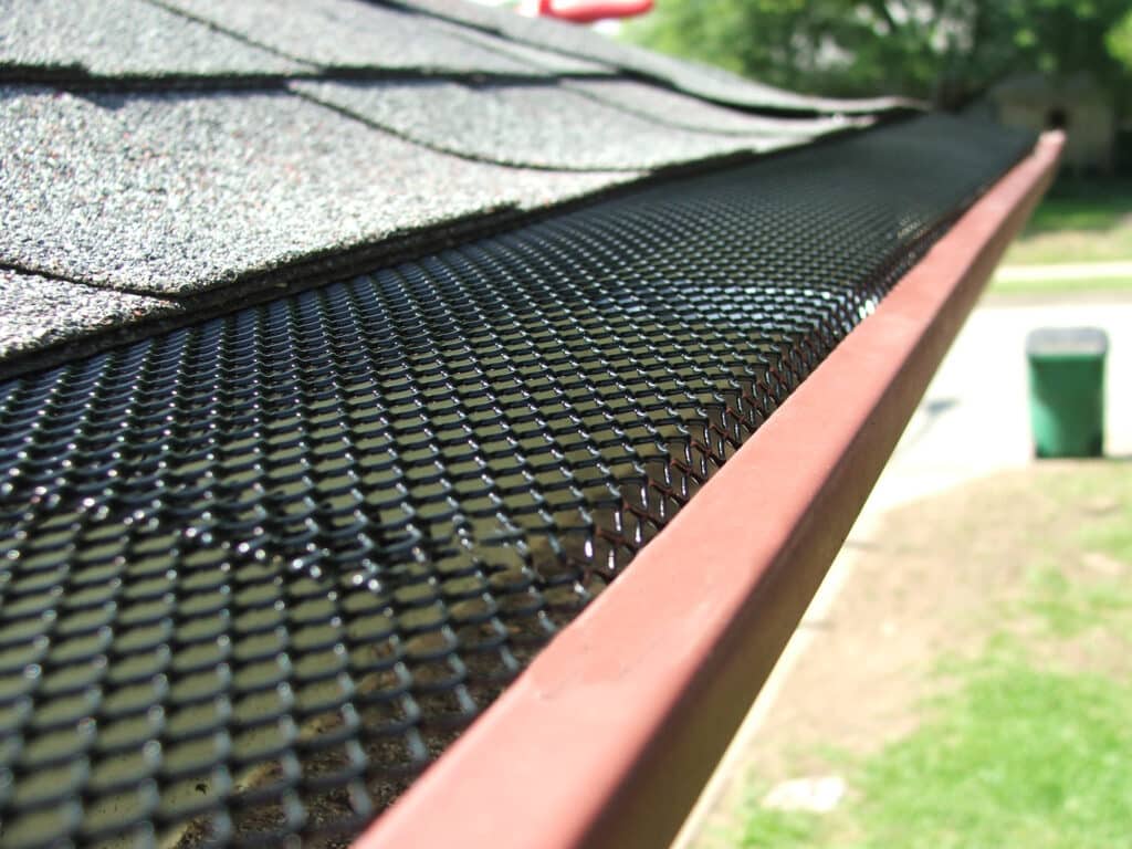 Black steel gutter guard on a gutter on a house