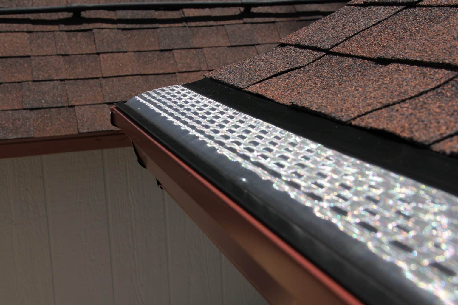 Stainless steel mesh gutter guard on a gutter on a house