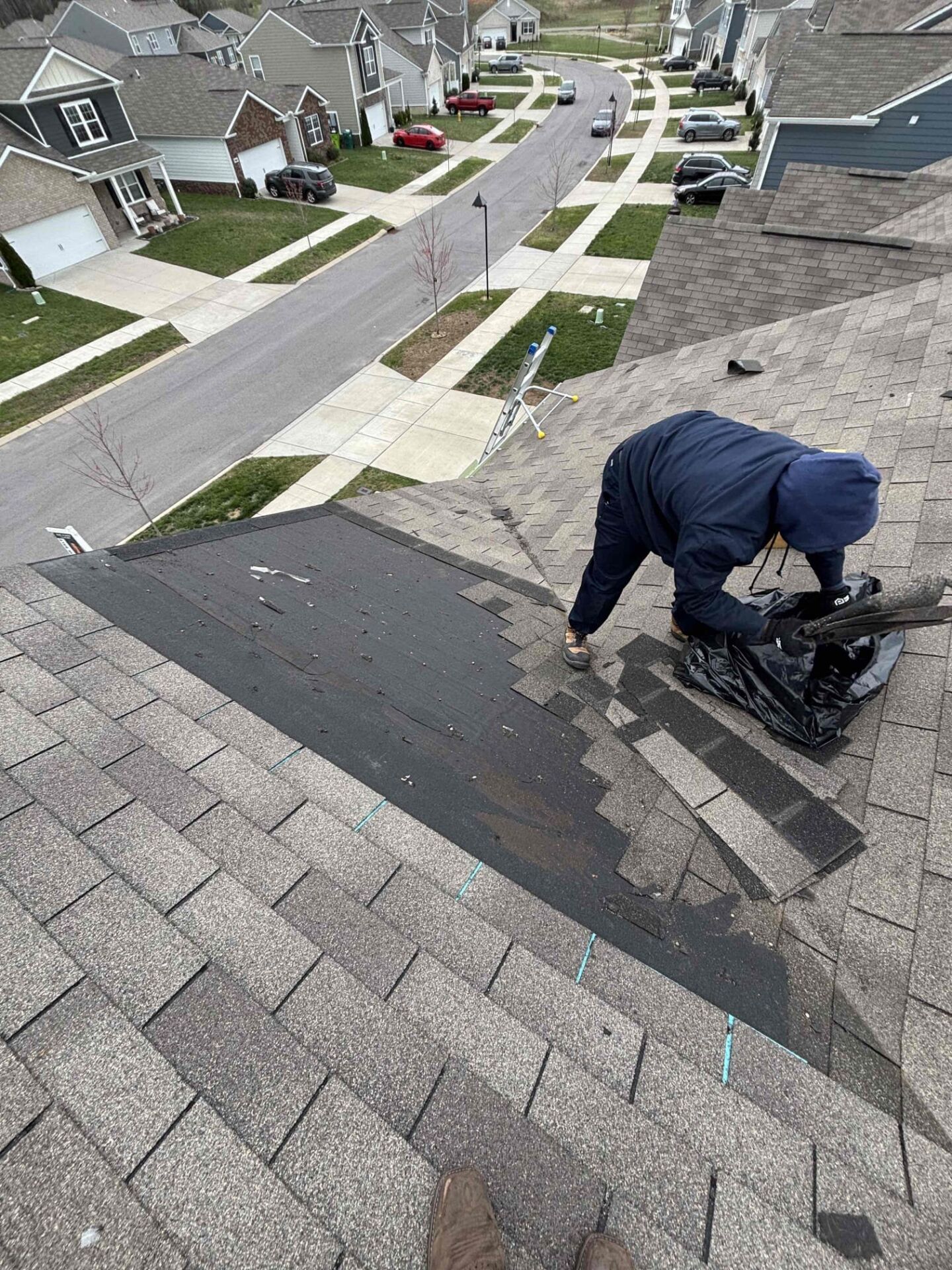 A mr goodroof technician working on a roof valley in nashville