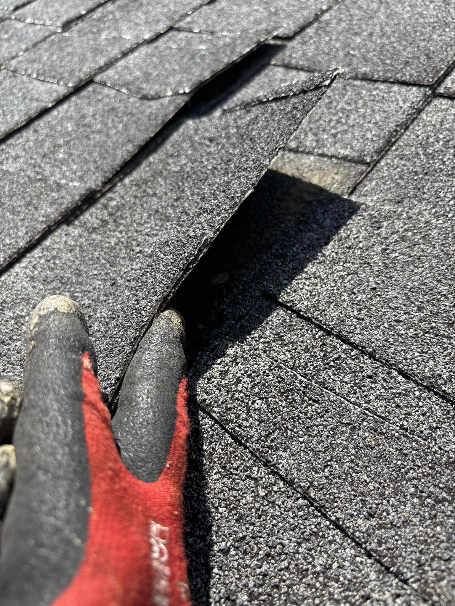 Lifted shingles found during a Mr. GoodRoof roof repair inspection